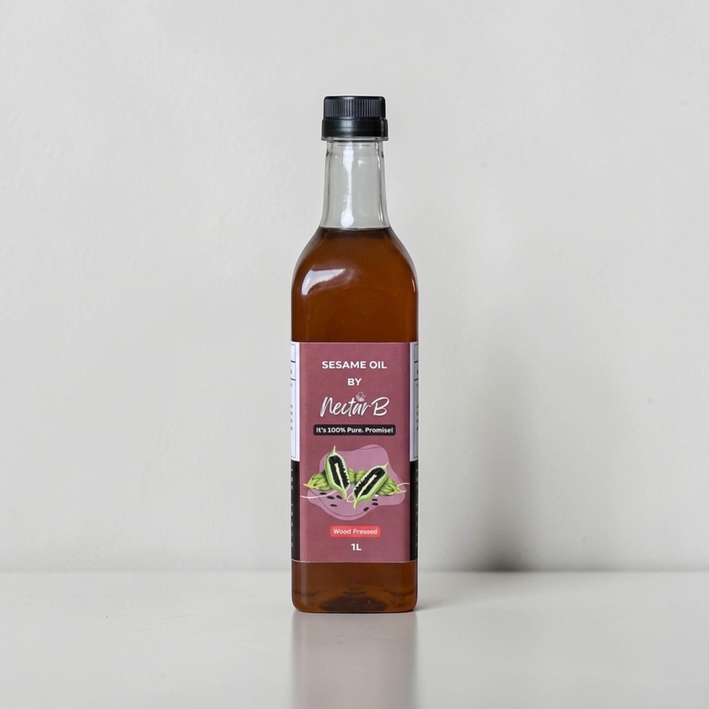 Wood Pressed Sesame Oil, 1L: glass bottle of dark red-brown oil, maroon label