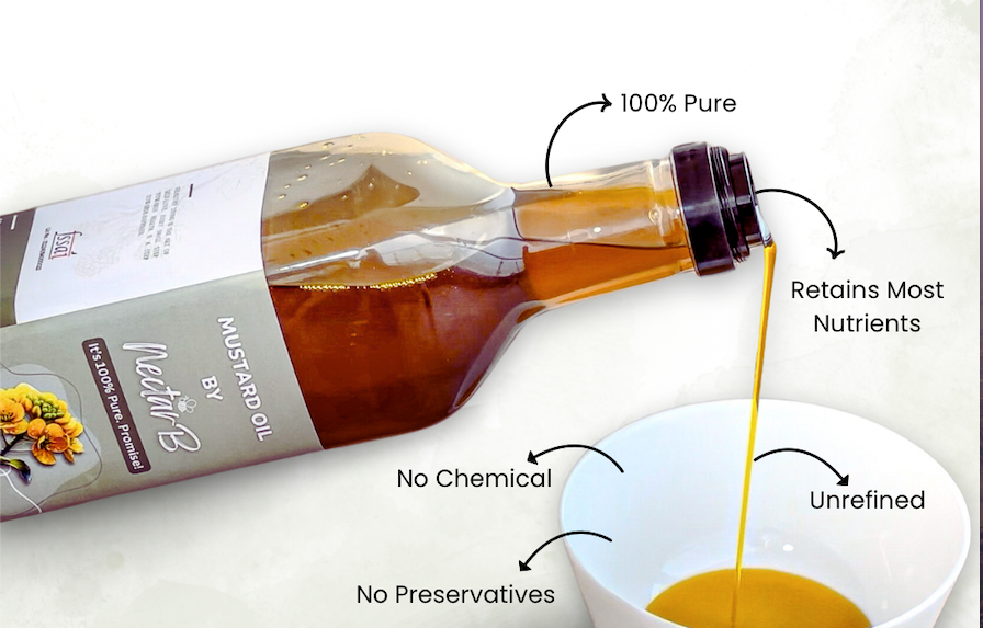 Wood pressed mustard oil poured from a tilted bottle into a white bowl